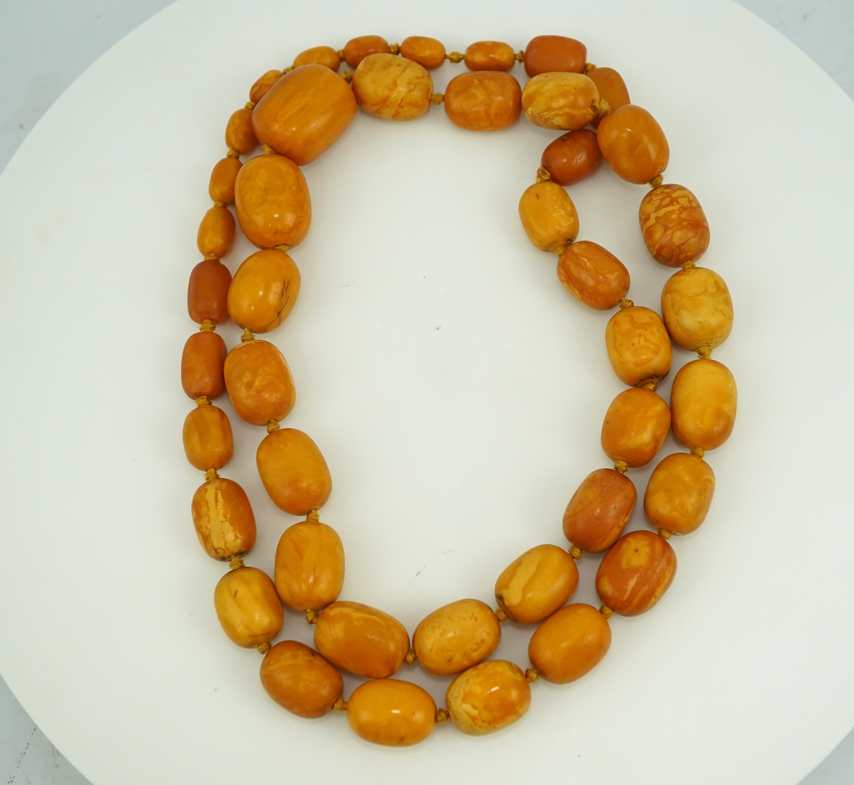 A single strand graduated oval amber bead necklace